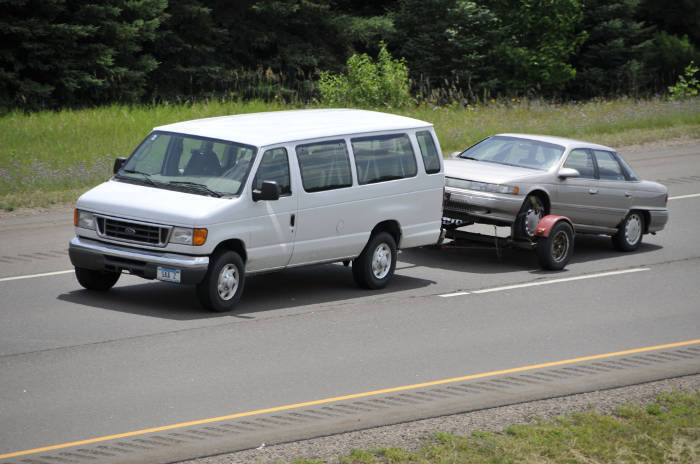 Van with Tow Dolly Pulling Car